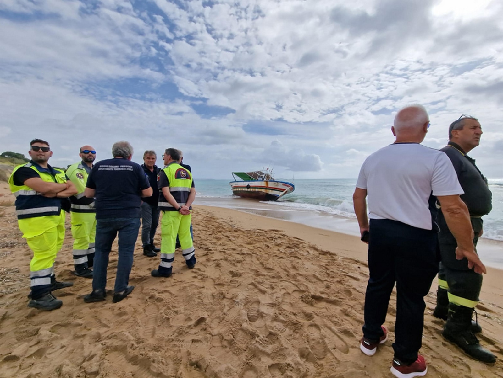 epa10944739 Officials inspect the site around the boat used for the crossing of the Mediterranean Sea by dozens of migrants on the beach of Marinella di Selinunte, Sicily, Italy 28 October 2023. Five bodies were recovered on the beach, as confirmed by the Italian Coast Guards. The boat and the bodies are believed to be washed up on the beach by currents, authorities said. Coast Guard and Finance Police vessels were searching the waters off the coast. Authorities detained 18 migrants who managed to reach the shore alive as they tried to get away from the beach, police said.  EPA/MAX FIRRERI