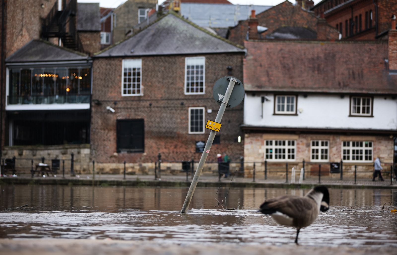 epa10949163 A submerged street sign stands in flood water in York, Britain, 30 October 2023. Severe flood warnings are in place in parts of North Yorkshire following weeks of heavy rain brought by storms Agnes and Babet. The Meteorological Office is forecasting strong winds and heavy rain across southern England as Storm Ciaran is expected to arrive on 01 November.  EPA/ADAM VAUGHAN