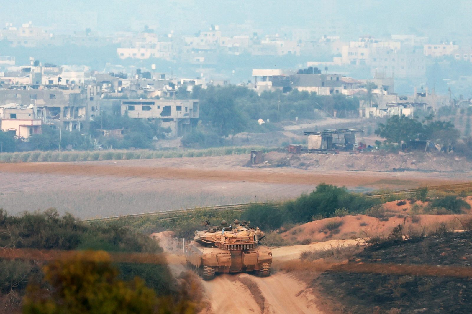 epa10952028 An Israeli tank maneuvers next to the Gaza Strip, as seen from Sderot, southern Israel, 01 November 2023. Overnight, combined IDF troops struck several targets throughout the Gaza Strip as part of its 'ground operations' in the Gaza Strip, the Israel Defense Forces (IDF) said on 01 November, adding that since 07 October the IDF struck over 11,000 targets in the Palestinian enclave. More than 8,000 Palestinians and at least 1,400 Israelis have been killed, according to the IDF and the Palestinian health authority, since Hamas militants launched an attack against Israel from the Gaza Strip on 07 October, and the Israeli operations in Gaza and the West Bank which followed it.  EPA/ATEF SAFADI
