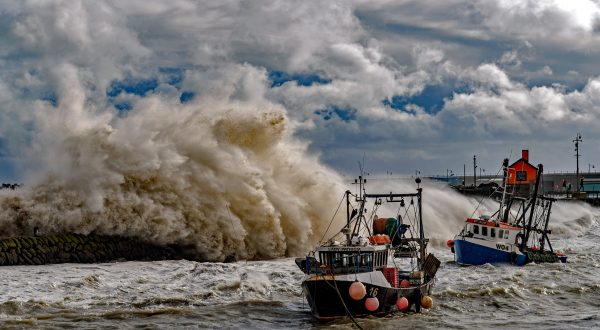 epa10954643 Fishing trawlers in the sea as waves crash against the harbour wall during Storm Ciaran in Folkestone, Kent, Britain, 02 November 2023.  The storm is causing severe disruption in the south of England with strong winds and rain. Flooding is expected in 54 areas, according to the Environment Agency, most of which are on the south coast of England.  EPA/Stuart Brock