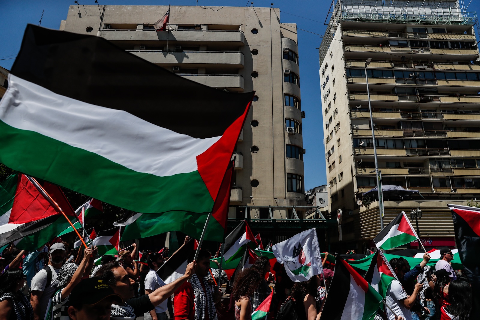 epa10958248 People wave the palestine flags as they demonstrate to support Palestinan peolpe of Gaza, in a march called by the Coordinator for Palestine, which brings together more than 20 social organizations and the Palestinian Community in Chile, through the center of Santiago, Chile, 04 November 2023. Thousands of Israelis and Palestinians have died since the militant group Hamas launched an unprecedented attack on Israel from the Gaza Strip on 07 October, and the Israeli strikes on the Palestinian enclave which followed it.  EPA/Ailen DIaz