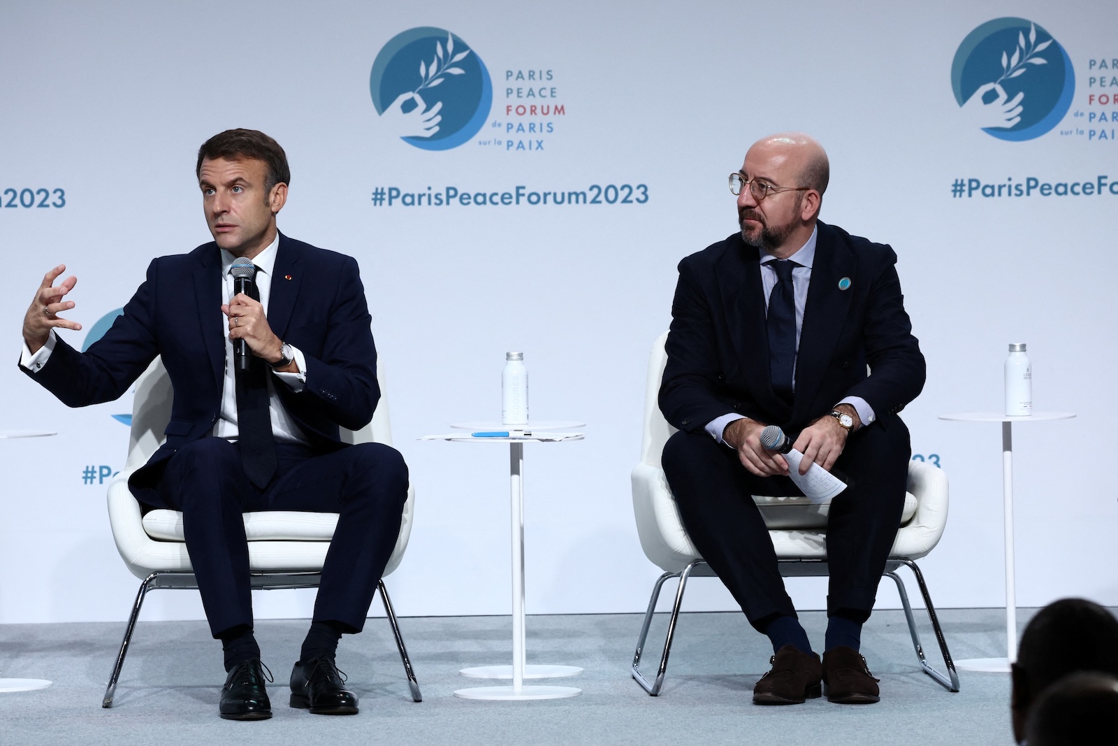 epa10968077 French President Emmanuel Macron (L) delivers a speech as European Council President Charles Michel listens during the opening ceremony of the 6th edition of the Paris Peace Forum at the Palais Brongniart in Paris, France, 10 November 2023. The annual Paris Peace Forum brings together governments, businesses, NGOs and others seeking dialogue to find solutions for global challenges. This year's theme is 'Seeking Common Ground in a World of Rivalry'.  EPA/STEPHANIE LECOCQ / POOL  MAXPPP OUT
