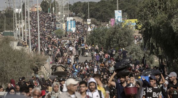 epa10970503 Palestinians evacuating to the southern Gaza Strip, make their way along Salah al-Din Street in Bureij, 11 November 2023. More than 11,000 Palestinians and at least 1,400 Israelis have been killed, according to the Israel Defense Forces (IDF) and the Palestinian health authority, since Hamas militants launched an attack against Israel from the Gaza Strip on 07 October, and the Israeli operations in Gaza and the West Bank which followed it.  EPA/HAITHAM IMAD