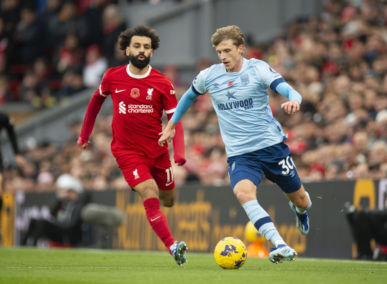epa10971628 Mohamed Salah (L) of Liverpool in action with Mads Roerslev (R) of Brentford during the English Premier League soccer match between Liverpool FC and Brentford FC, in Liverpool, Britain, 12 November 2023.  EPA/PETER POWELL EDITORIAL USE ONLY. No use with unauthorized audio, video, data, fixture lists, club/league logos or 'live' services. Online in-match use limited to 120 images, no video emulation. No use in betting, games or single club/league/player publications.