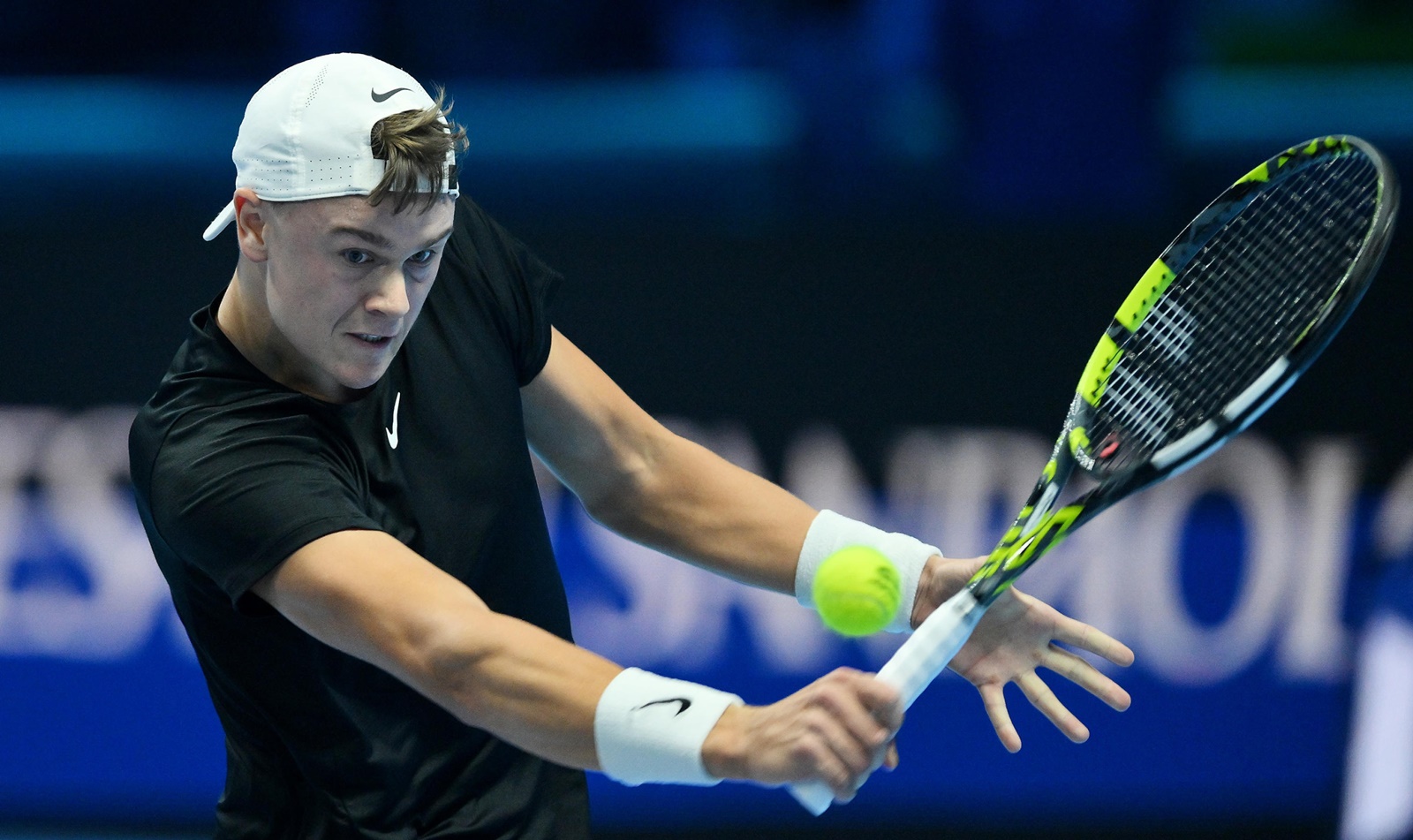 epa10972462 Holger Rune of Denmark in action during his singles match against Novak Djokovic of Serbia at the Nitto ATP Finals 2023 tennis tournament at the Pala Alpitour arena in Turin, Italy, 12 November 2023.  EPA/ALESSANDRO DI MARCO