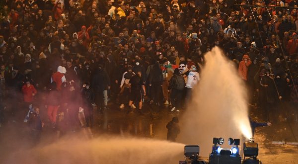 epa10978823 Police use water canon during a protest of  soccer fans demanding the immediate resignation of the president of the Bulgarian Football Union Borislav Mihailov and other leading members, in Sofia, Bulgaria, 16 November 2023.  EPA/VASSIL DONEV