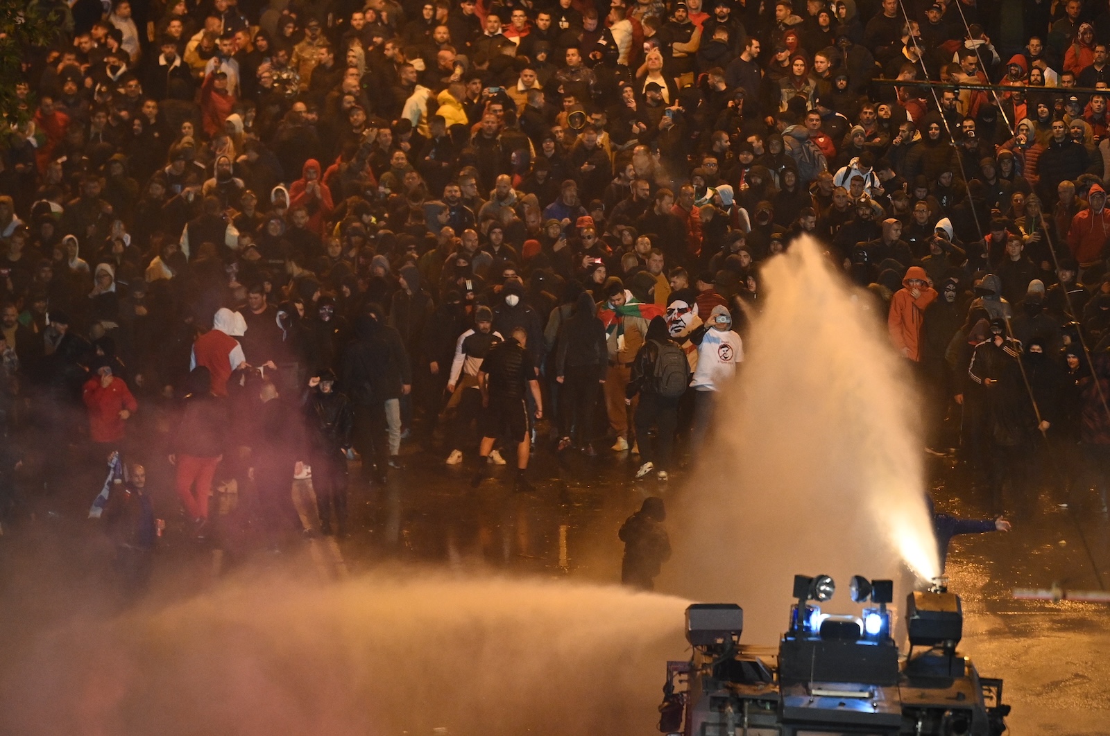 epa10978823 Police use water canon during a protest of  soccer fans demanding the immediate resignation of the president of the Bulgarian Football Union Borislav Mihailov and other leading members, in Sofia, Bulgaria, 16 November 2023.  EPA/VASSIL DONEV
