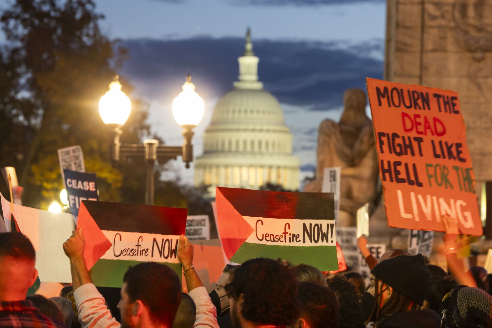 epa10981716 The US Capitol rises behind pro-Palestinian activists calling for an Israeli ceasefire in Gaza during a protest outside Union Station in Washington, DC, USA, 17 November 2023. Thousands of Israelis and Palestinians have died since the militant group Hamas launched an unprecedented attack on Israel from the Gaza Strip on 07 October, and the Israeli strikes on the Palestinian enclave which followed it.  EPA/JIM LO SCALZO