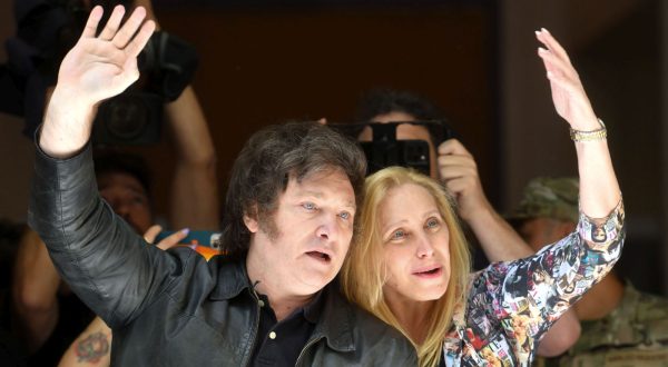 epa10985242 Argentina's presidential candidate for La Libertad Avanza (far-right), Javier Milei (L), and his sister Karina Milei (R) greet supporters after voting in Buenos Aires, Argentina, 19 November 2023. Milei said he was 'calm' and 'satisfied' after voting  in the ballot between him and the pro-government candidate, Sergio Massa, despite the 'campaign of fear' that, he said, his rival made against him. The polling stations in Argentina were opened for the second round of the presidential elections, where the next President and vice president will be elected.  EPA/ENRIQUE GARCIA MEDINA