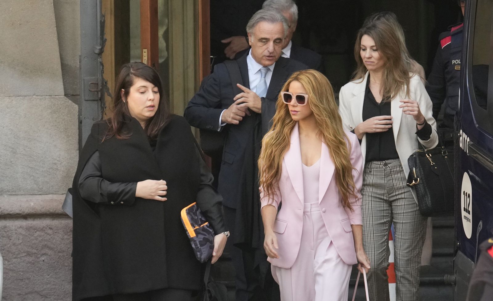 epa10985684 Colombian singer Shakira (C, in pink), accopanied by members of her defense team, leaves Barcelona Provincial Court on the first day of her trial for allegedly defrauding Spanish tax officials of 14.5 million euro in taxes between 2012 and 2014, in Barcelona city, Catalonia region, north-eastern Spain, 20 November 2023. Shakira has eventually secured a deal with Spanish prosecutors which means she avoids spending up to eight years in jail in exchange for paying a millionaire fine.  EPA/Quique Garcia