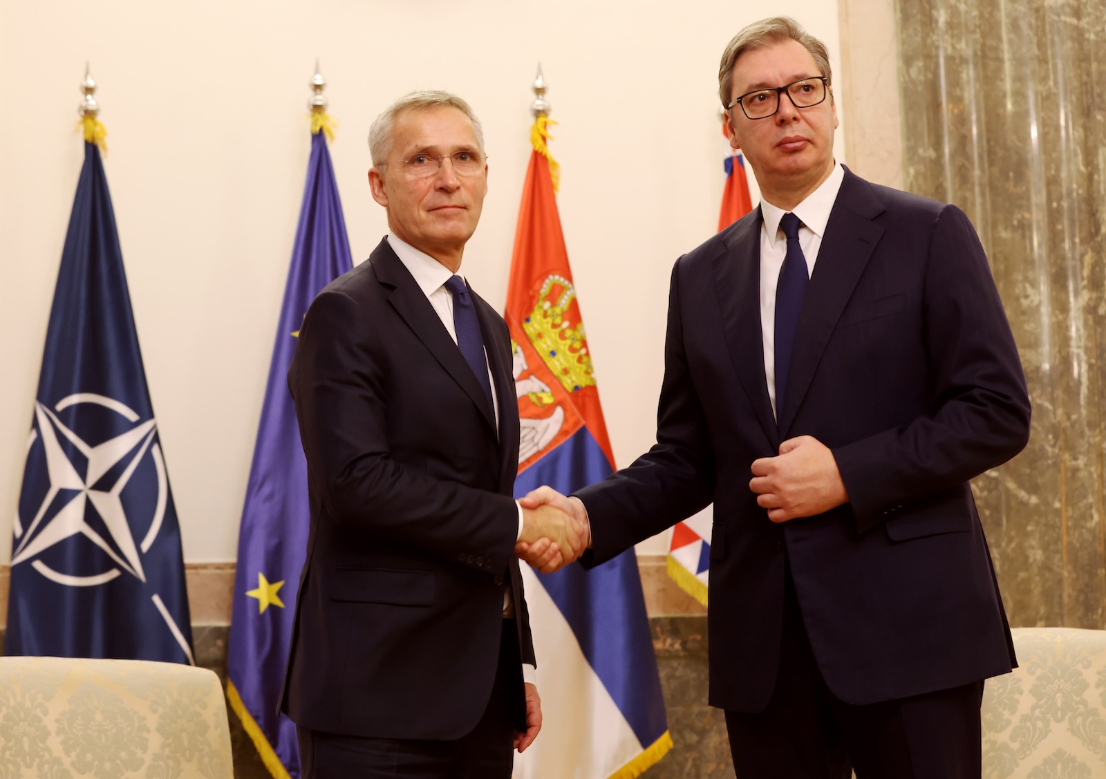 epa10987117 Serbian President Aleksandar Vucic (R) shakes hands with NATO Secretary General Jens Stoltenberg (L) before their meeting in Belgrade, Serbia, 21 November 2023.  EPA/ANDREJ CUKIC