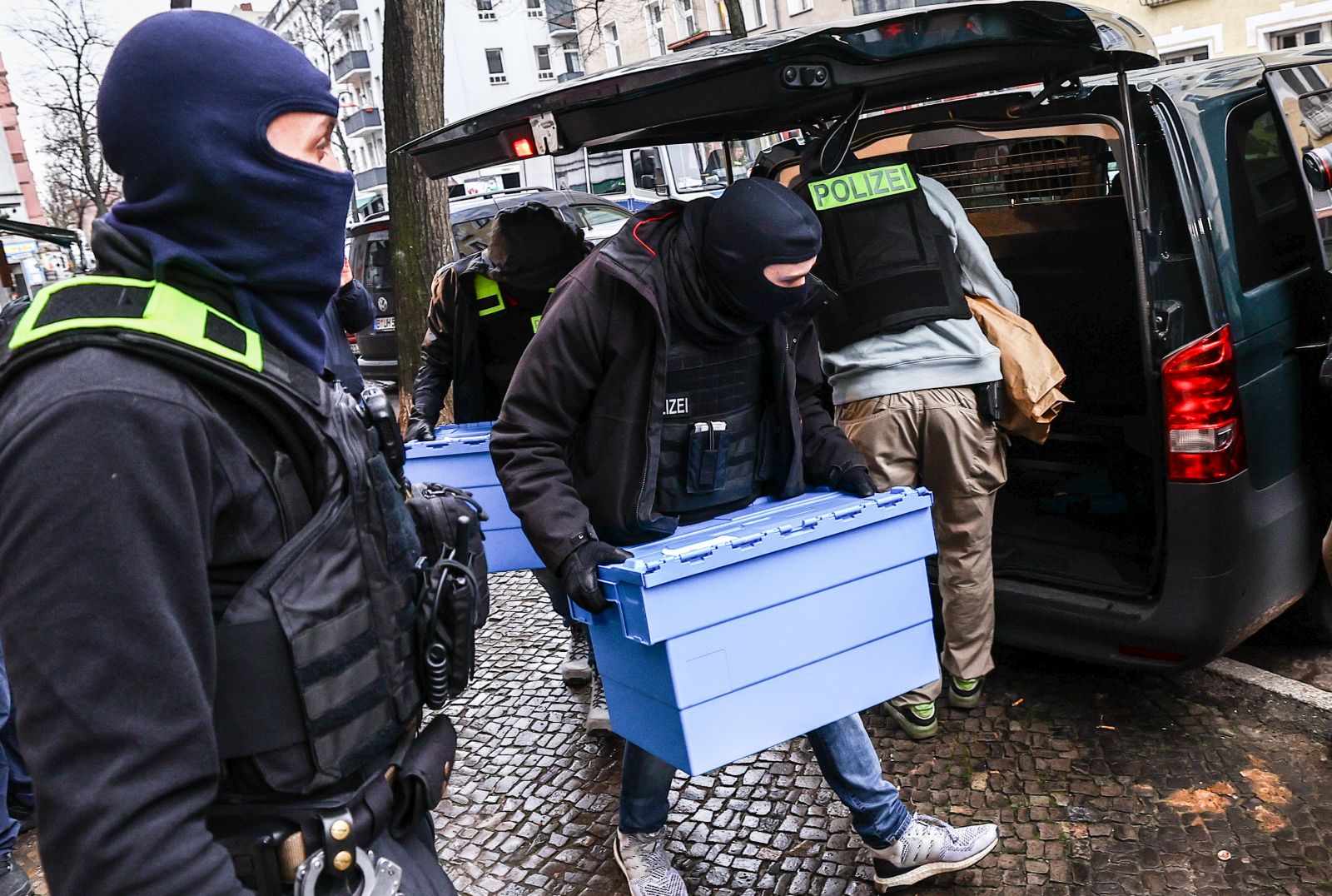 epa10990557 Police officers carry evidence during a raid on suspected Hamas and Samidoun properties, in Berlin, Germany, 23 November 2023. A total of 15 properties were searched on the morning of 23 November in connection with a ban on the Palestinian militant group Hamas and the pro-Palestinian group Samidoun, the German Interior Ministry announced. The searches were conducted in Berlin, Lower Saxony, North Rhine-Westphalia and Schleswig-Holstein. On 02 November, the German government banned activities in Germany related to Hamas, a designated terrorist organization, and the international network 'Samidoun - Palestinian Solidarity Network'. The sub-organization 'Samidoun Deutschland' was banned and dissolved on the same day.  EPA/FILIP SINGER