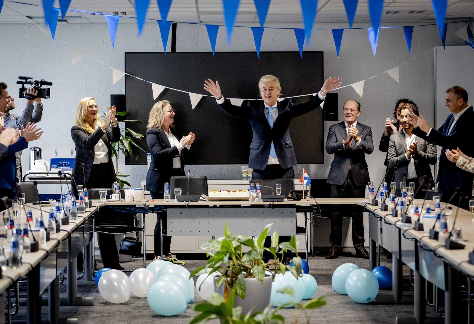 epa10990601 Leader of Freedom party (PVV) Geert Wilders (C-R) gestures next to Dutch MP Fleur Agema (C-L) one day after the House of Representatives elections, The Hague, Netherlands, 23 November 2023. Wilders believes that the PVV can no longer be ignored after the "mega victory" in the House of Representatives elections. He calls on other parties to work together and step over their own shadows. The PVV party is set to win the parliamentary elections with 37 seats after most votes were counted.  EPA/REMKO DE WAAL