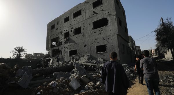 epa10991328 Palestinians walk past the rubble following overnight Israeli airstrikes in the east of Khan Younis, southern Gaza Strip, 23 November 2023. More than 14.000 Palestinians and at least 1,200 Israelis have been killed, according to the Gaza Government media office and the Israel Defense Forces (IDF), since Hamas militants launched an attack against Israel from the Gaza Strip on 07 October, and the Israeli operations in Gaza and the West Bank which followed it.  EPA/MOHAMMED SABER