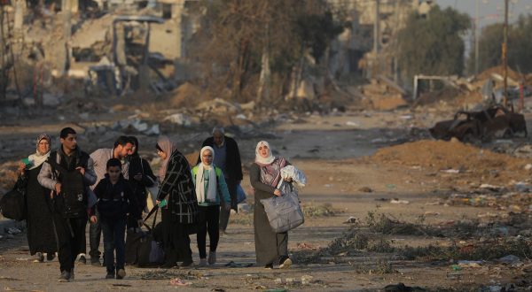 epa10993169 Palestinians walk after crossing from the northern Gaza Strip to the southern Gaza Strip along Salah Al Din road in the central Gaza Strip, 24 November 2023. After Israel and Hamas agreed to a four-day ceasefire, mediated by Qatar, the US, and Egypt, that came into effect at 05:00 AM GMT on 24 November, some Palestinians who were still in central Gaza moved towards the south while others already displaced in the south went back to the northern part to check on relatives they had left behind and  on their homes to collect salvageable belongings. As part of the ceasefire, the agreement included that 50 Israeli hostages, women and children, are to be released by Hamas. 150 Palestinian women and children that were detained in Israeli prisons are to be released in exchange. More than 14,000 Palestinians and at least 1,200 Israelis have been killed, according to the Gaza Government media office and the Israel Defense Forces (IDF), since Hamas militants launched an attack against Israel from the Gaza Strip on 07 October, and the Israeli operations in Gaza and the West Bank which followed it.  EPA/MOHAMMED SABER