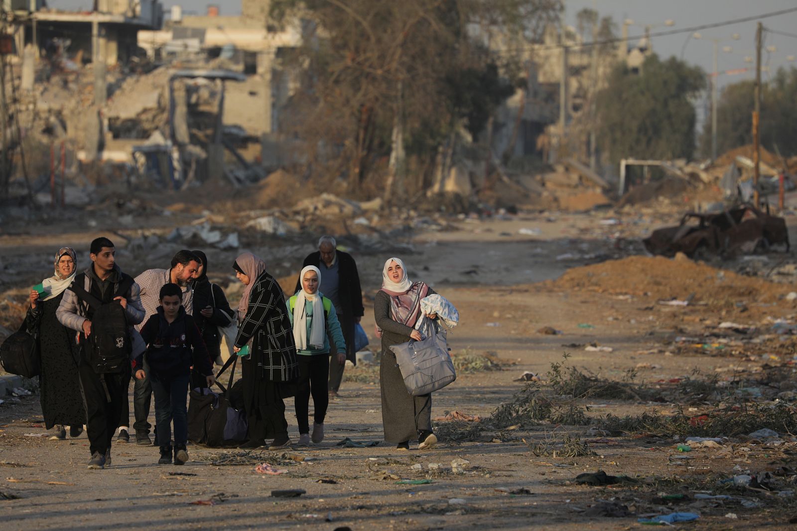 epa10993169 Palestinians walk after crossing from the northern Gaza Strip to the southern Gaza Strip along Salah Al Din road in the central Gaza Strip, 24 November 2023. After Israel and Hamas agreed to a four-day ceasefire, mediated by Qatar, the US, and Egypt, that came into effect at 05:00 AM GMT on 24 November, some Palestinians who were still in central Gaza moved towards the south while others already displaced in the south went back to the northern part to check on relatives they had left behind and  on their homes to collect salvageable belongings. As part of the ceasefire, the agreement included that 50 Israeli hostages, women and children, are to be released by Hamas. 150 Palestinian women and children that were detained in Israeli prisons are to be released in exchange. More than 14,000 Palestinians and at least 1,200 Israelis have been killed, according to the Gaza Government media office and the Israel Defense Forces (IDF), since Hamas militants launched an attack against Israel from the Gaza Strip on 07 October, and the Israeli operations in Gaza and the West Bank which followed it.  EPA/MOHAMMED SABER