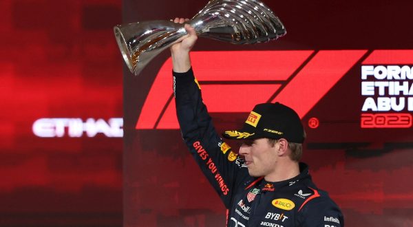 epa10996344 Dutch Formula One driver Max Verstappen of Red Bull Racing celebrates on the podium with his trophy after winning the Formula 1 Abu Dhabi Grand Prix in Abu Dhabi, United Arab Emirates, 26 November 2023.  EPA/ALI HAIDER