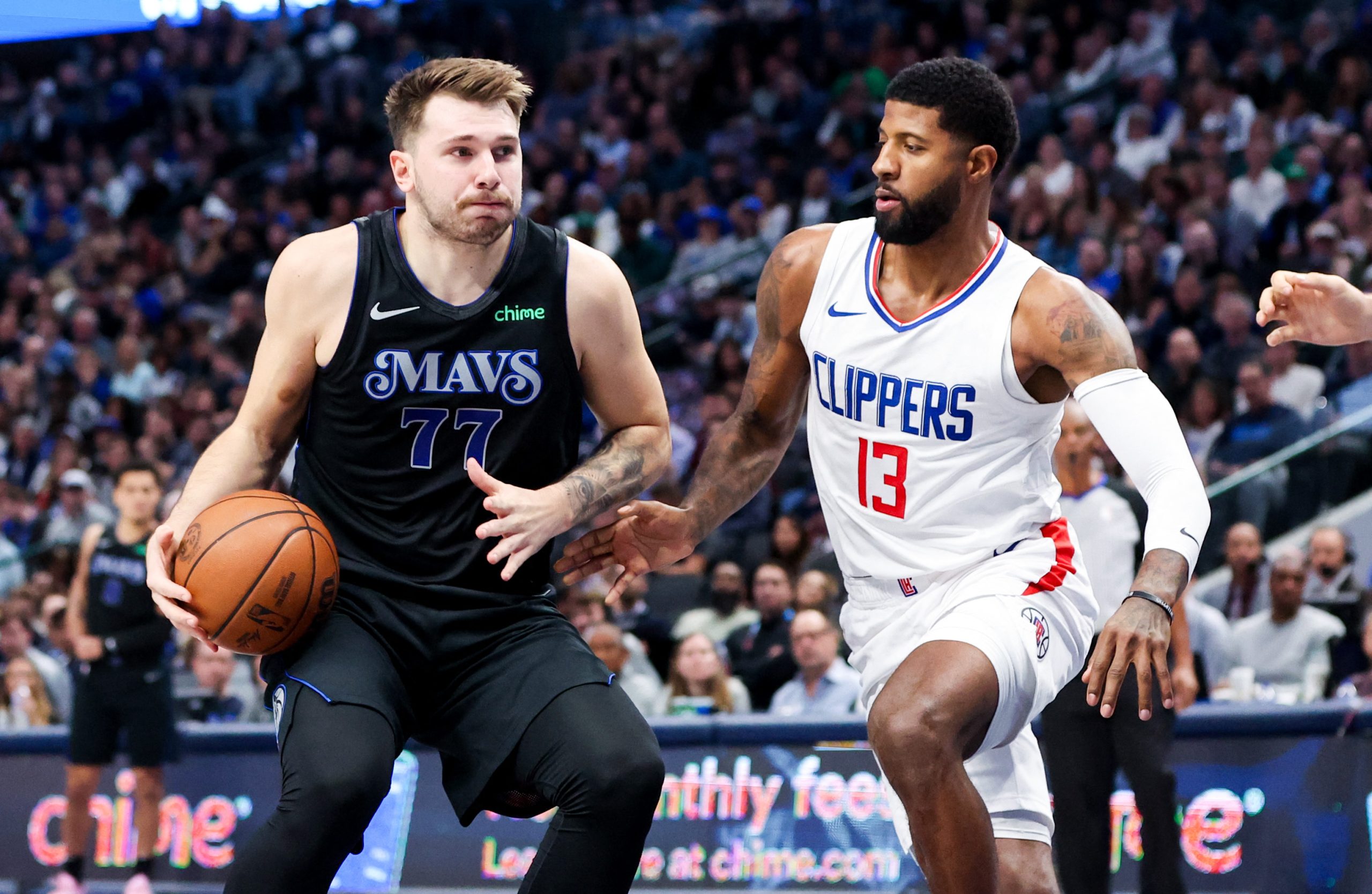 Nov 10, 2023; Dallas, Texas, USA;  Dallas Mavericks guard Luka Doncic (77) controls the ball as LA Clippers forward Paul George (13) defends during the first quarter at American Airlines Center. Mandatory Credit: Kevin Jairaj-USA TODAY Sports Photo: Kevin Jairaj/REUTERS
