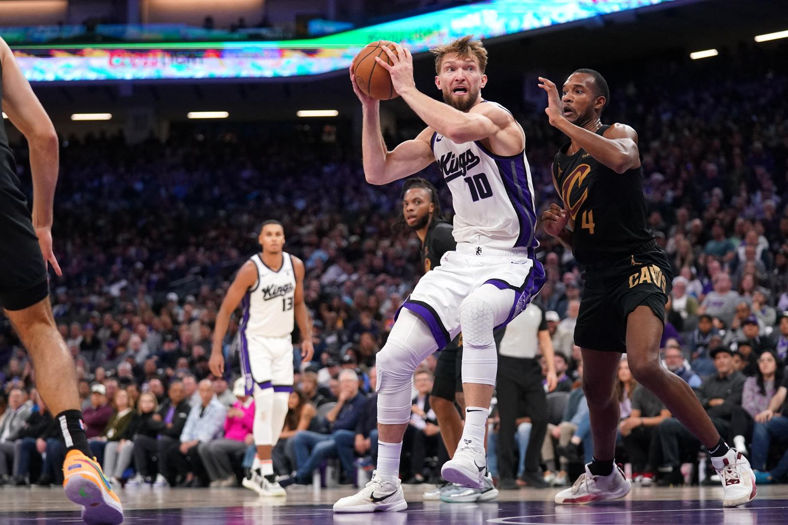 Nov 13, 2023; Sacramento, California, USA; Sacramento Kings forward Domantas Sabonis (10) spins towards the basket next to Cleveland Cavaliers center Evan Mobley (4) in the fourth quarter at the Golden 1 Center. Mandatory Credit: Cary Edmondson-USA TODAY Sports Photo: Cary Edmondson/REUTERS