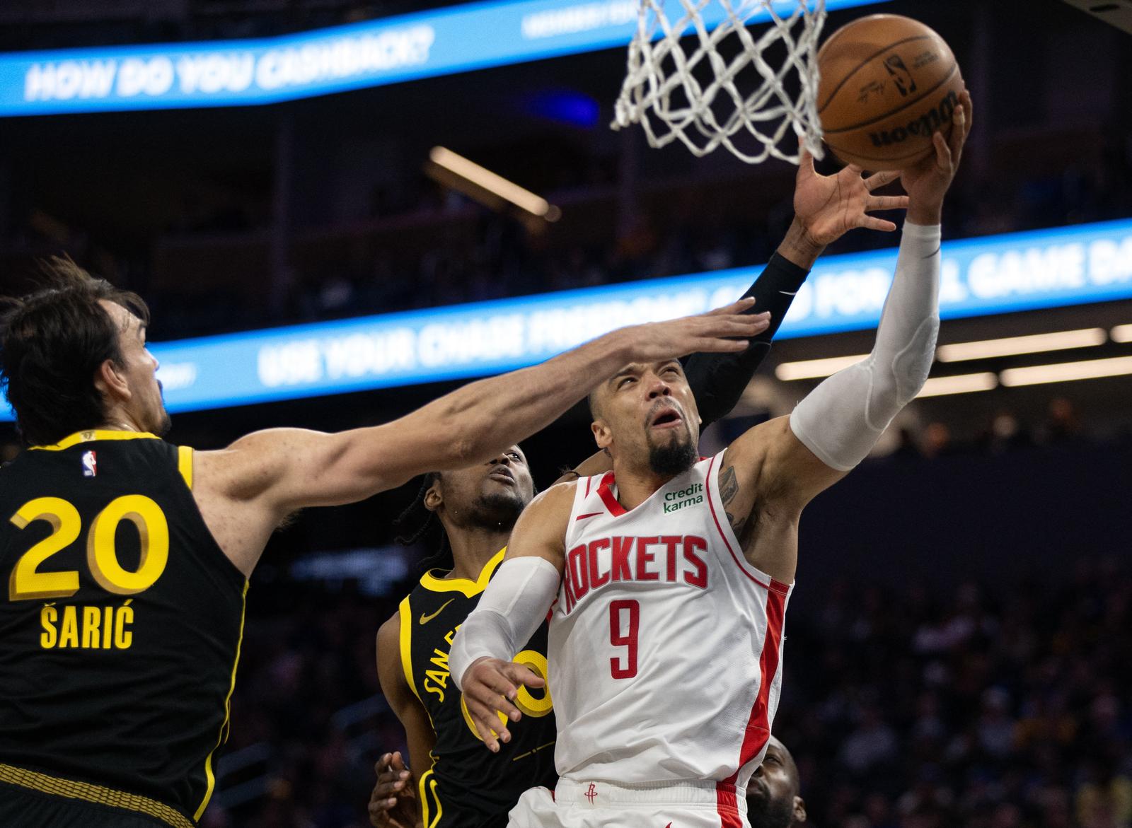 Nov 20, 2023; San Francisco, California, USA; Houston Rockets guard Dillon Brooks (9) drives against Golden State Warriors center Dario Saric (20) and forward Jonathan Kuminga (00) during the third quarter at Chase Center. Mandatory Credit: D. Ross Cameron-USA TODAY Sports Photo: D. Ross Cameron/REUTERS