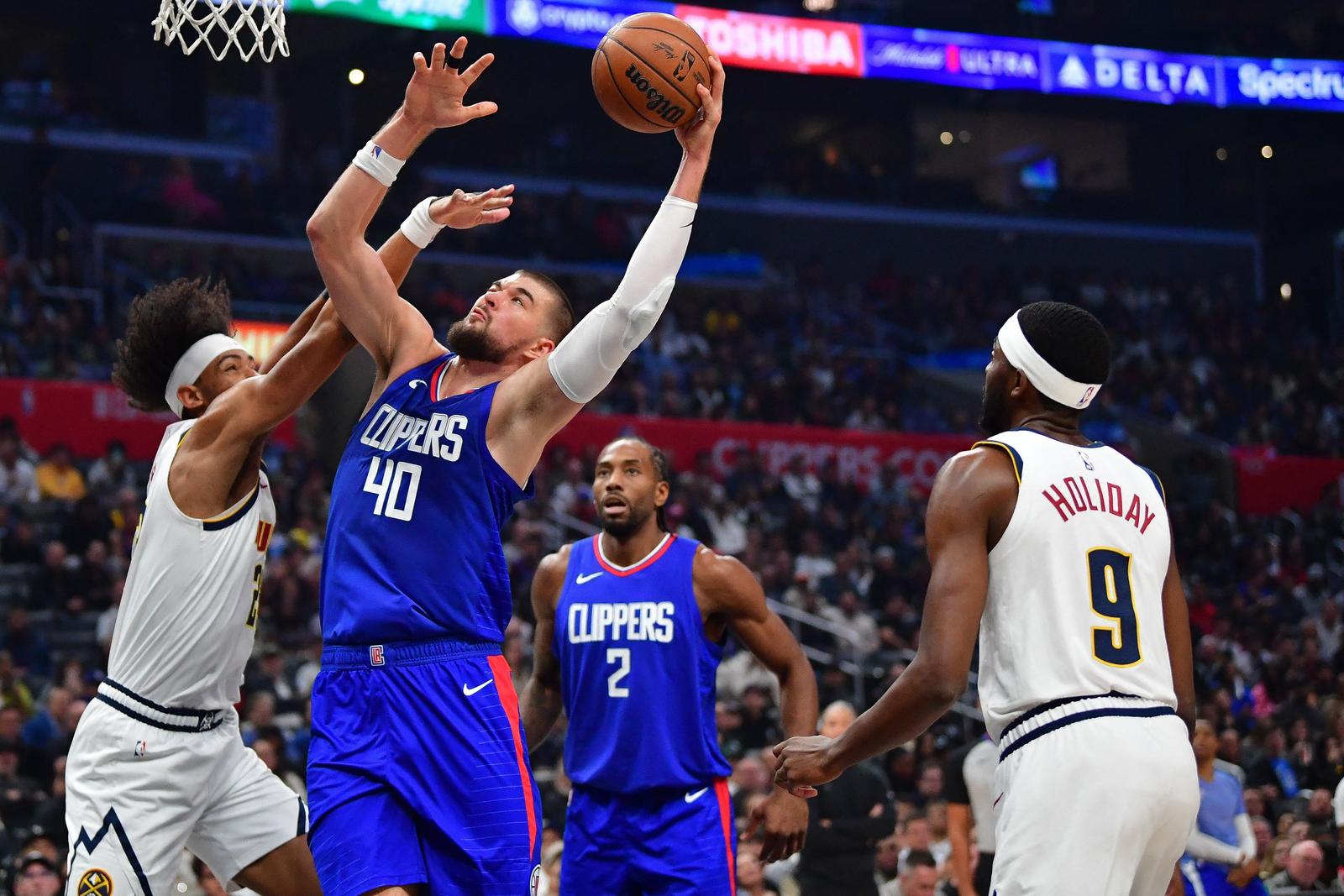 Nov 27, 2023; Los Angeles, California, USA; Los Angeles Clippers center Ivica Zubac (40) moves to the basket against Denver Nuggets forward Zeke Nnaji (22) during the first half at Crypto.com Arena. Mandatory Credit: Gary A. Vasquez-USA TODAY Sports Photo: Gary A. Vasquez/REUTERS