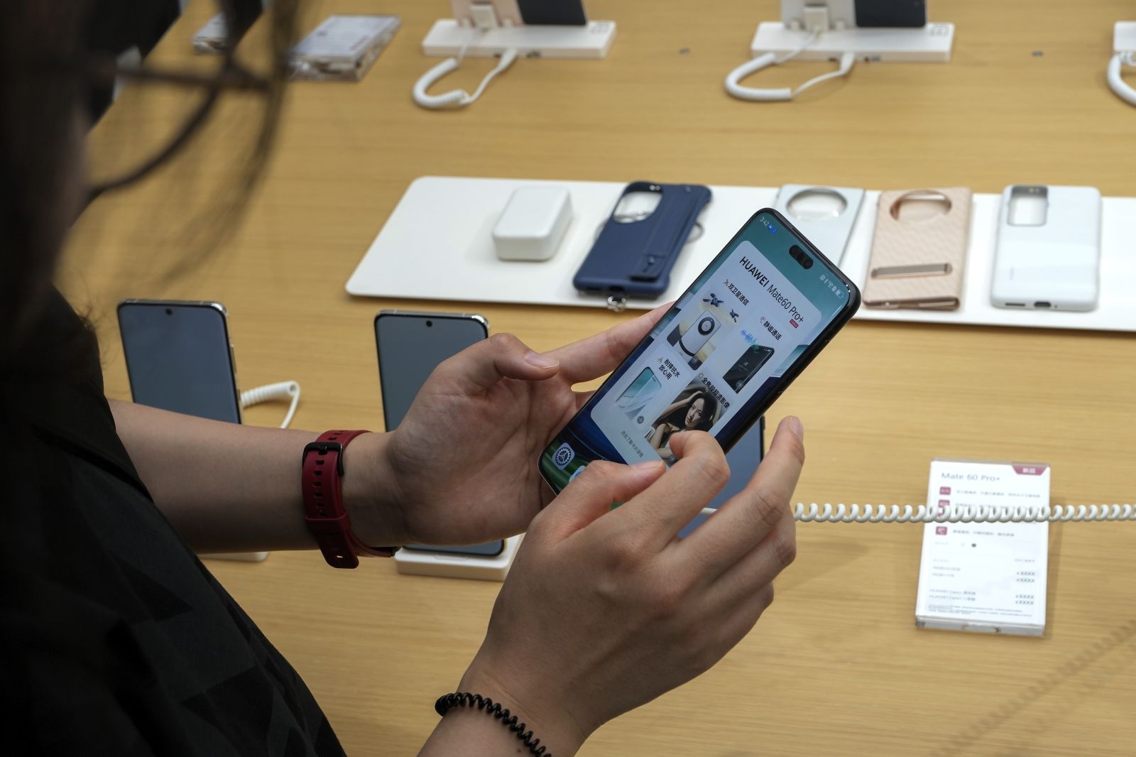 A customer tries out the Mate 60 Pro+, Huawei's latest smartphone during the Huawei new product launch conference, at a Huawei store in Beijing, Monday, Sept. 25, 2023. (AP Photo/Andy Wong)