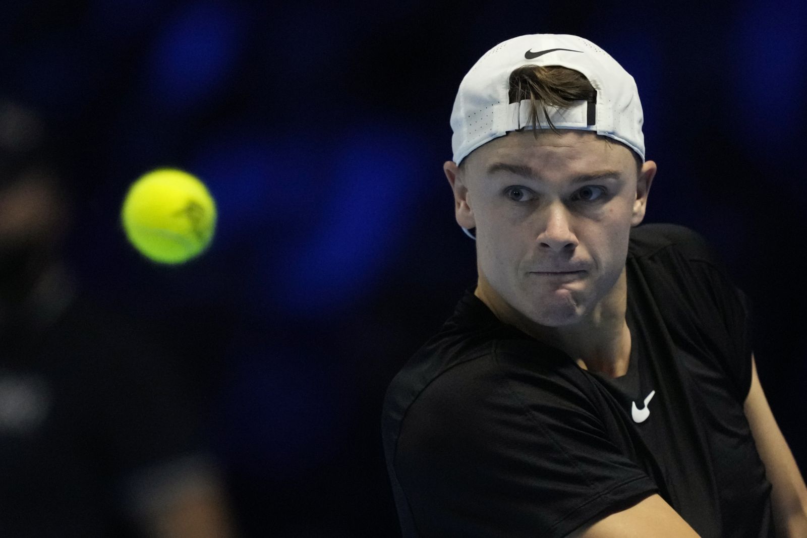 Denmark's Holger Rune returns the ball to Italy's Jannik Sinner during their singles tennis match of the ATP World Tour Finals at the Pala Alpitour, in Turin, Italy, Thursday, Nov. 16, 2023. (AP Photo/Antonio Calanni)