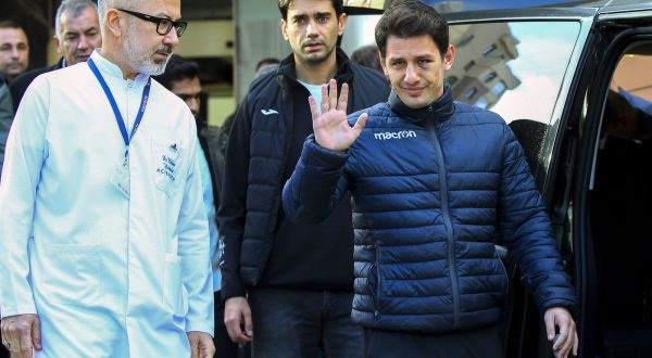 Turkish soccer referee Halil Umut Meler, right, gestures as he leaves Acibadem hospital in Ankara, Wednesday, Dec. 13, 2023. The Turkish Football Federation has suspended all league games after the president of a first-division soccer club punched a referee in the face at the end of a top-flight match. (AP Photo/Ali Unal)