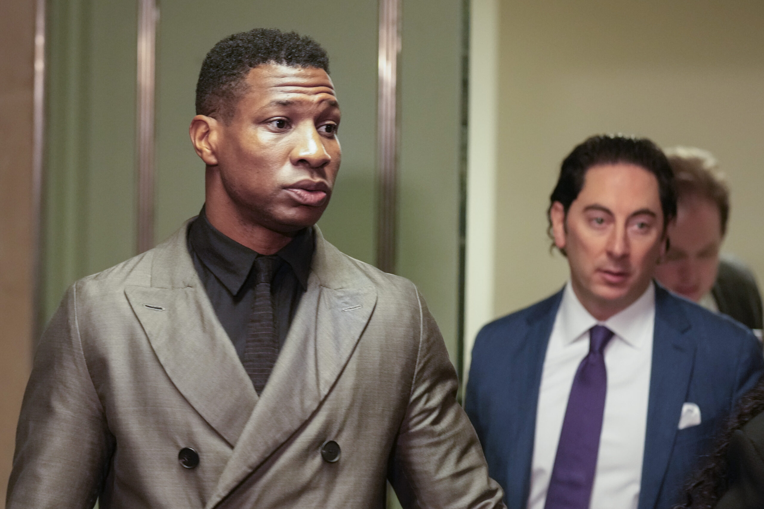 Jonathan Majors, left, enters a courtroom at the Manhattan criminal courts in New York, Monday, Dec. 18, 2023. The actor is accused of assaulting his then-girlfriend as the two struggled over a phone in the back seat of a chauffeured car. (AP Photo/Seth Wenig)