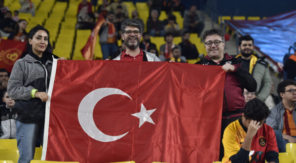 Turkish soccer fans wave their national flag as they wait for the Super Cup match between Galatasaray and Fenerbahce at Al Awal Park of King Saud University in Riyadh, Saudi Arabia, Friday, Dec. 29, 2023. (AP Photo)