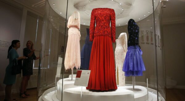 In this photo taken Monday, July 1, 2013, dresses of Princess Diana are displayed at the Fashion Rules exhibition at Kensington Palace in London, Monday, July 1, 2013. Opening on 4 July, a new glamorous exhibit at Kensington Palace showcases how the styles of three royal ladies; Queen Elizabeth II, her sometimes risque sister Margaret, and the glamorous Princess Diana, each reflected and influenced the trends of their fashion heyday. (AP Photo/Frank Augstein)