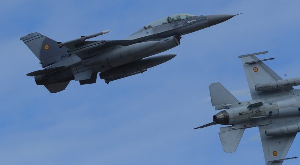 epa10973339 Two Romanian military jet pilots fly their F16 Falcons during a demonstration following the opening ceremony for the European F-16 Training Center, held at the 86th Air Base 'Lieutenant Aviator Gheorghe Mociornita', in Borcea, 156 kilometers south-east from Bucharest, Romania, 13 November 2023. The ETFC it is the first European dedicated training facility outside the United States territory that had all the means for training F16 pilots in order to facilitate the interoperability between NATO member countries. According to the project contract, Romanian Defense Ministry put the 86th Air Base at the training hub's disposal, including the tech training facilities and logistic support. The Netherlands already gave four pieces of F16 jet fighters for the training flights, and US company Lockheed Martin comes with the instructors and maintenance. At the EFTC are supposed to get the training the Ukrainian pilots that will handle the F16 that Ukraine will receive from its western allies, according to the NATO decision.  EPA/Robert Ghement