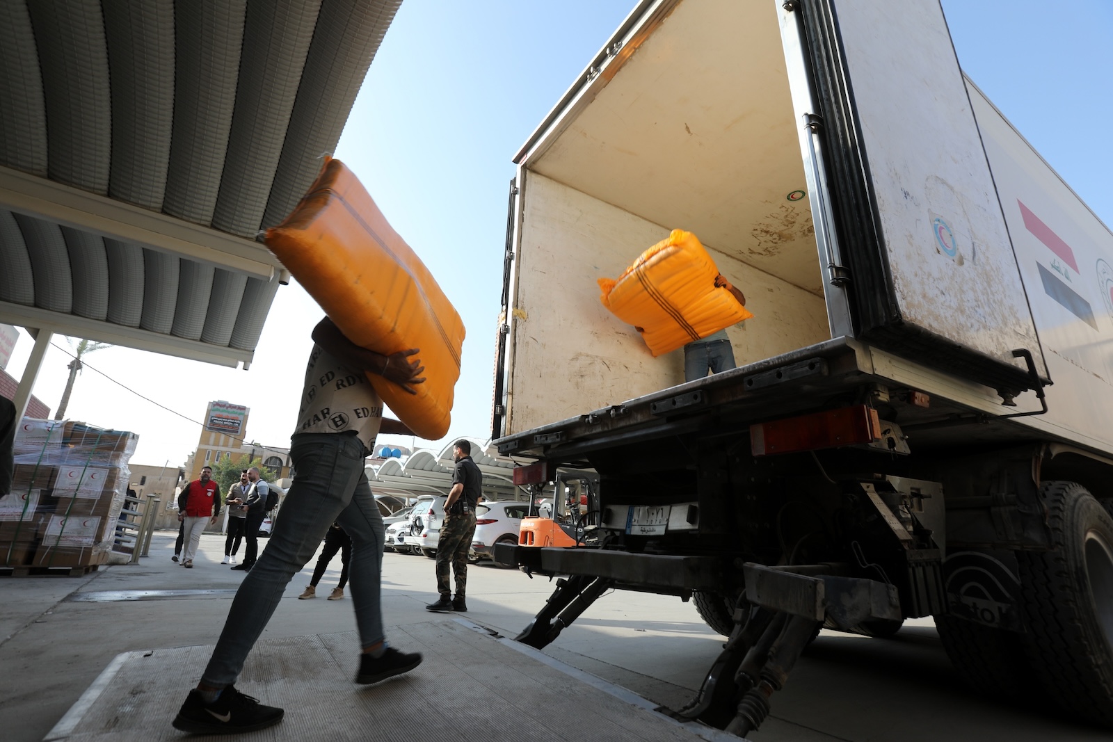 epa10995921 Members of the Iraqi Red Crescent load medical supplies and medicines into a truck at the Iraqi Red Crescent headquarters in Baghdad, Iraq, 26 November 2023. The Red Crescent of Iraq is sending some 20 tons of humanitarian and medical supplies to Gaza amid the conflict between Israel and Hamas. The warring sides, Israel and Hamas, both had agreed to a four-day ceasefire mediated by Qatar, the USA, and Egypt, that came into effect on 24 November that includes a deal for the release of people held by Hamas in the Gaza Strip in exchange for Palestinians detained in Israeli prisons as well as allowing humanitarian aid to be transported into the Gaza strip. Thousands of people have died since Hamas militants launched an attack against Israel from the Gaza Strip on 07 October, and the Israeli operations in Gaza and the West Bank which followed it.  EPA/AHMED JALIL