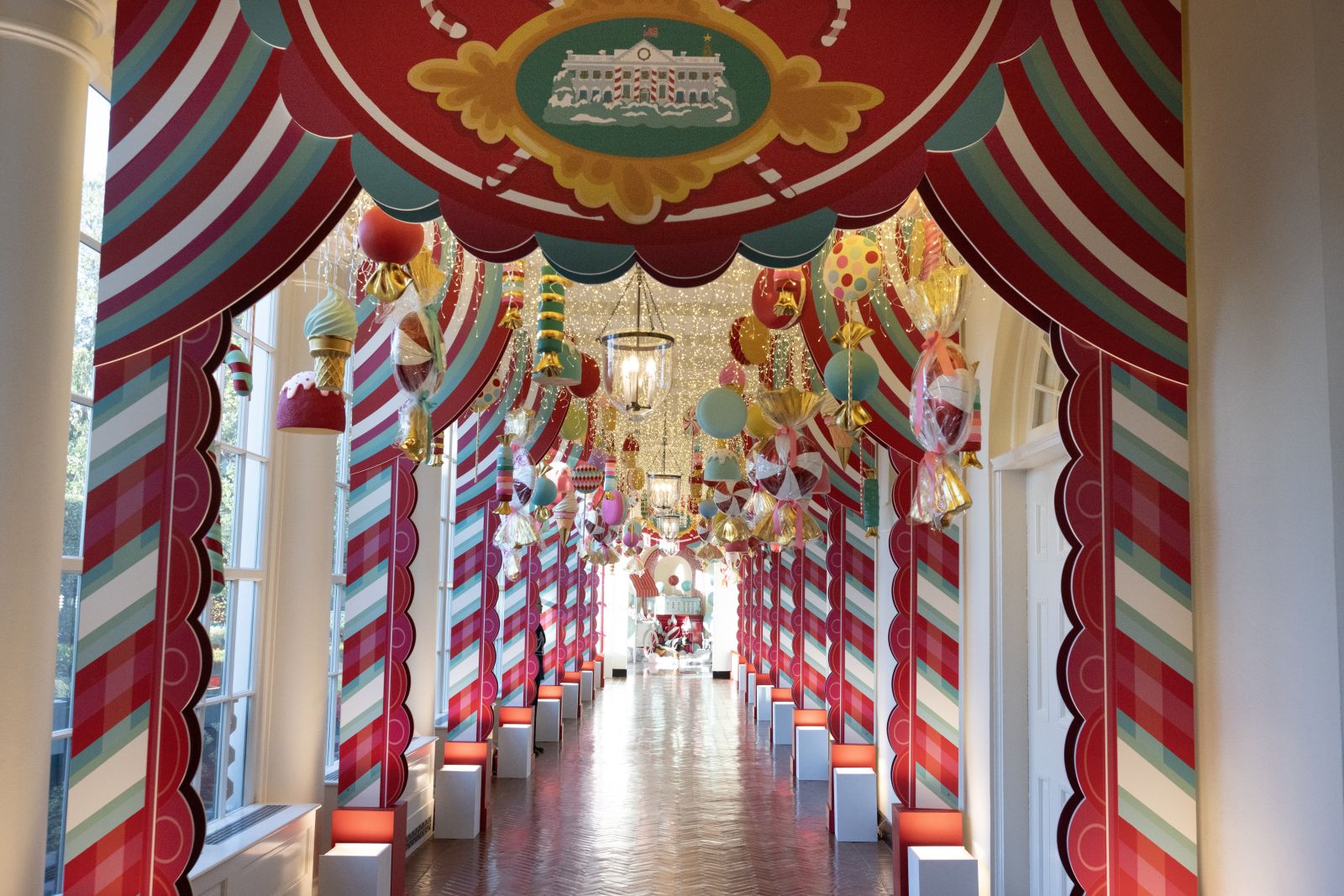 epa10997842 Holiday deocrations in the hallway that runs along the Jacqueline Kennedy Garden of the White House, during a media preview for the 2023 White House holiday display themed the 'Magic, Wonder, and Joy' of the holidays, in Washington, DC, USA, 27 November 2023. The White House is expected to welcome one hundred thousand visitors during the holiday season. Some of the 2023 display includes over twenty-two thousand bells, almost thirty-four thousand ornaments, nearly fifteen thousand feet of ribbon, and ninety-eight Christmas trees across the White House complex.  EPA/MICHAEL REYNOLDS