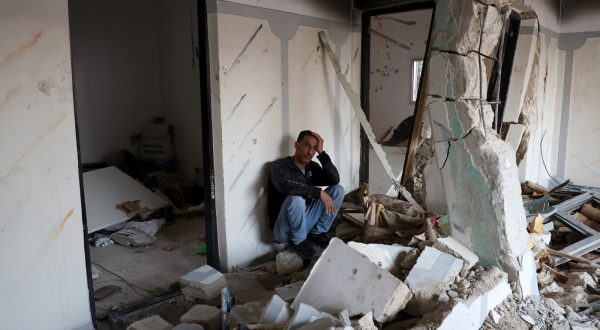 epa11002070 A Palestinian man reacts inside a damaged building following an Israeli raid on Jenin refugee camp, near the West Bank city of Jenin, 29 November 2023. According to the Palestinian Health Ministry, four Palestinians were killed, including two children, and eight others were injured in an overnight Israeli raid on the Jenin camp and ensuing clashes.  EPA/ALAA BADARNEH