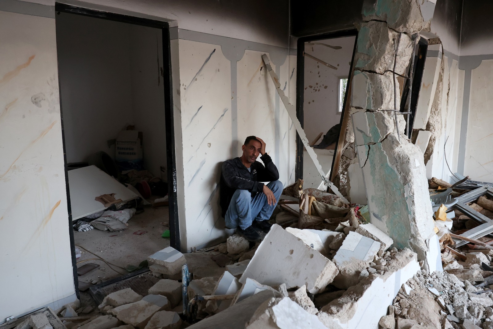 epa11002070 A Palestinian man reacts inside a damaged building following an Israeli raid on Jenin refugee camp, near the West Bank city of Jenin, 29 November 2023. According to the Palestinian Health Ministry, four Palestinians were killed, including two children, and eight others were injured in an overnight Israeli raid on the Jenin camp and ensuing clashes.  EPA/ALAA BADARNEH