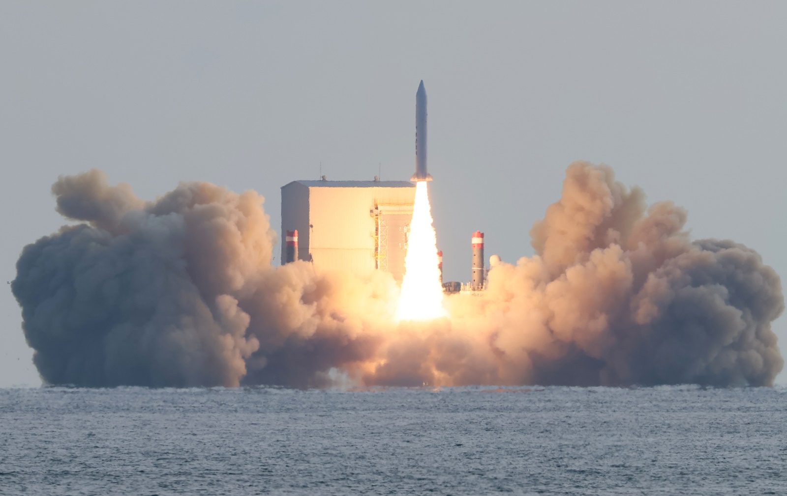 epa11010200 South Korea's third launch of a solid-fuel space rocket from a barge floating in waters takes place about 4 kilometers south of Jeju Island, South Korea, 04 December 2023, successfully placing a small Earth observation satellite into orbit at an altitude of about 650 km. The 100-kilogram synthetic aperture radar (SAR) satellite was made by Hanwha Systems.  EPA/YONHAP SOUTH KOREA OUT