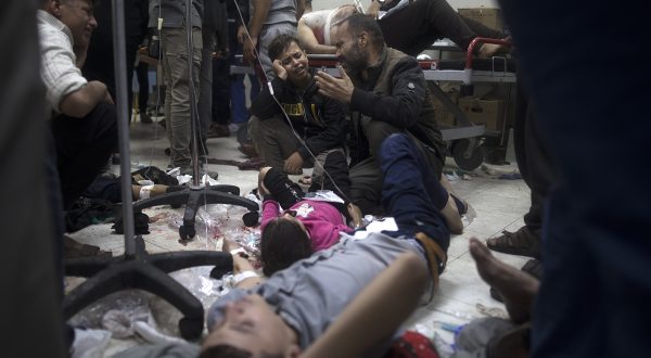 epa11011547 A man reacts next to his wounded daughter as she lies on the floor at Nasser Hospital in Khan Yunis, southern Gaza Strip, 05 December 2023, following Israeli air strikes on southern Gaza. Israeli forces resumed military strikes on Gaza after a week-long truce ended on 01 December. More than 15,500 Palestinians and at least 1,200 Israelis have been killed, according to the Palestinian Ministry of Health and the Israel Defense Forces (IDF), since Hamas militants launched an attack against Israel from the Gaza Strip on 07 October, and the Israeli operations in Gaza and the West Bank which followed it.  EPA/HAITHAM IMAD