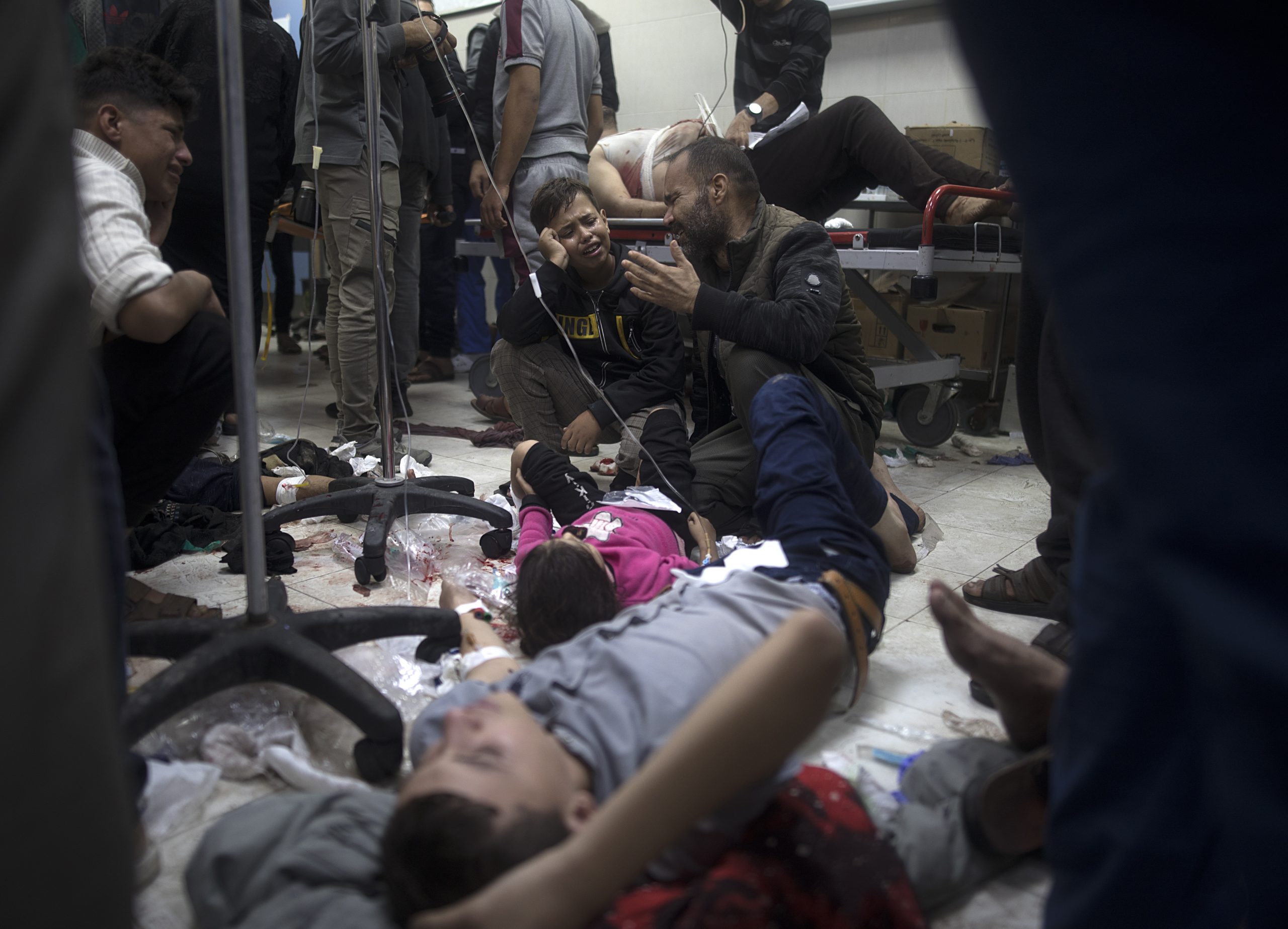 epa11011547 A man reacts next to his wounded daughter as she lies on the floor at Nasser Hospital in Khan Yunis, southern Gaza Strip, 05 December 2023, following Israeli air strikes on southern Gaza. Israeli forces resumed military strikes on Gaza after a week-long truce ended on 01 December. More than 15,500 Palestinians and at least 1,200 Israelis have been killed, according to the Palestinian Ministry of Health and the Israel Defense Forces (IDF), since Hamas militants launched an attack against Israel from the Gaza Strip on 07 October, and the Israeli operations in Gaza and the West Bank which followed it.  EPA/HAITHAM IMAD
