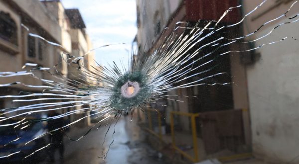 epa11017169 A bullet hole in the windscreen of a car following an Israeli military raid at Al Farea refugee camp near the West Bank city of Tubas, 08 December 2023. According to the Palestinian Health Ministry, six Palestinians were killed and 12 others were injured during clashes that erupted after Israeli troops raided their camp.  EPA/ALAA BADARNEH