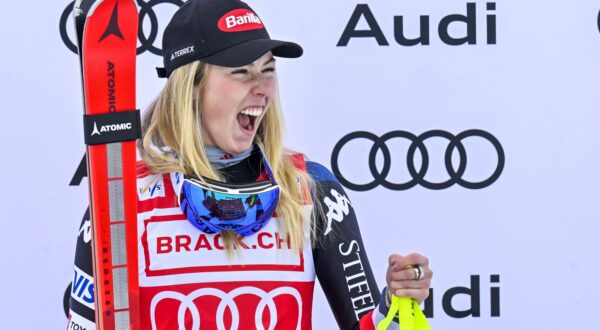 epa11018768 Winner Mikaela Shiffrin of USA celebrates on the podium for the Women Downhill race of the FIS Alpine Skiing World Cup in St. Moritz, Switzerland, 09 December 2023.  EPA/GIAN EHRENZELLER