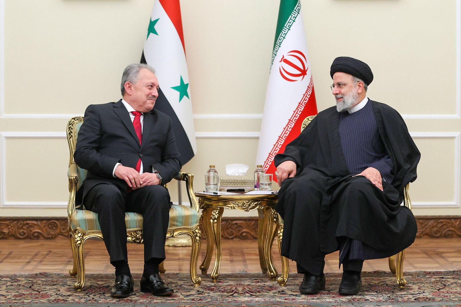 epa11019903 A handout picture made available by the Iranian presidential office shows, Iranian President Ebrahim Raisi (R) in talks with Syria Prime minister Hussein Arnuos (L), in Tehran, Iran, 09 December 2023.  EPA/IRANIAN PRESIDENTIAL OFFICE / HANDOUT  HANDOUT EDITORIAL USE ONLY/NO SALES HANDOUT EDITORIAL USE ONLY/NO SALES
