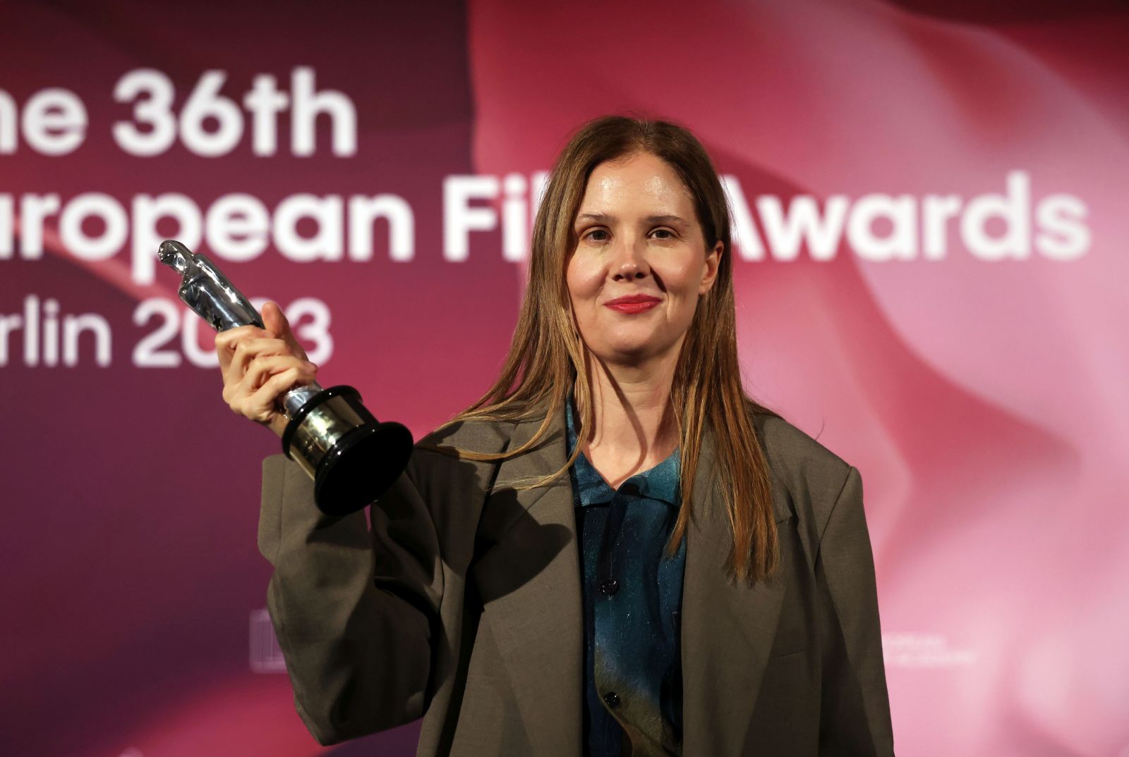 epa11020213 French Director Justine Triet poses with her European Director 2023 Award for 'Anatomy Of A Fall' during the 36th European Film Awards in the Arena Berlin in Berlin, Germany, 09 December 2023.  EPA/CLEMENS BILAN