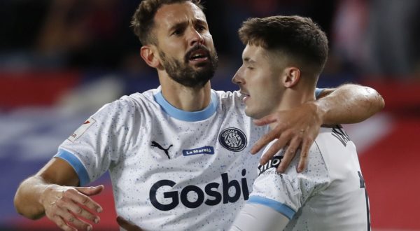 epa11022259 Girona's midfielder Valery Fernandez (R) jubilates with his teammate Uruguayan striker Cristhian Stuani after scoring the 1-3 lead during the Spanish LaLiga soccer match between FC Barcelona and Girona FC at Estadio Olimpico Lluis Companys stadium in Barcelona, Catalonia, Spain, 10 December 2023.  EPA/Andreu Dalmau