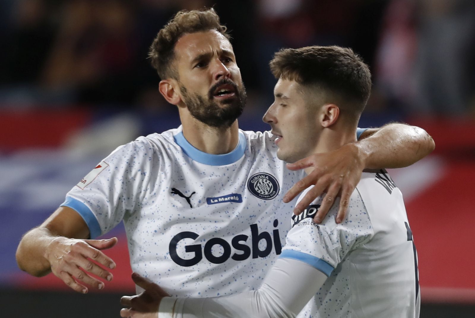 epa11022259 Girona's midfielder Valery Fernandez (R) jubilates with his teammate Uruguayan striker Cristhian Stuani after scoring the 1-3 lead during the Spanish LaLiga soccer match between FC Barcelona and Girona FC at Estadio Olimpico Lluis Companys stadium in Barcelona, Catalonia, Spain, 10 December 2023.  EPA/Andreu Dalmau