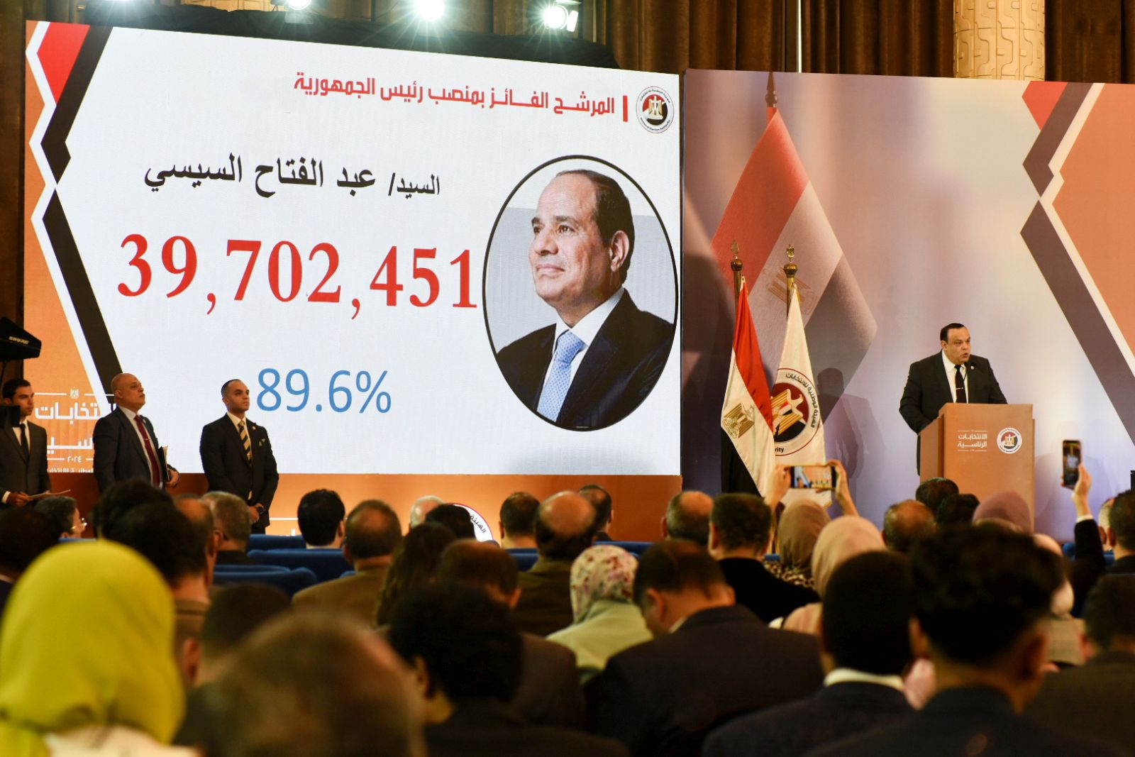epaselect epa11035920 Head of Egypt's National Election Authority Hazem Badawy (R) speaks next to a display showing the number of votes for President Abdel Fattah al-Sisi during a press conference to announce the results of the presidential elections, in Cairo, Egypt, 18 December 2023. Egypt's President Abdel Fattah al-Sisi won a new six-year term with 89.6 percent of the votes in the presidential elections held between 10 and 12 December, the election authority announced. The elections witnessed a turnout of 66.8 percent, with 44.7 million citizens voting in the elections at home and abroad, out of nearly 67 million eligible voters, according to the figures released by the authority.  EPA/TAREK WAJEH