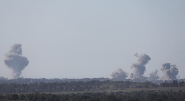 epa11044584 Smoke rises above Al-Bureij refugee camp in the central Gaza Strip following Israeli army shelling, as seen from an undisclosed location at the Gaza border, Israel, 26 December 2023. More than 20,000 Palestinians and at least 1,300 Israelis have been killed, according to the Palestinian Health Ministry and the Israel Defense Forces (IDF), since Hamas militants launched an attack against Israel from the Gaza Strip on 07 October, and the Israeli operations in Gaza and the West Bank which followed it.  EPA/ATEF SAFADI
