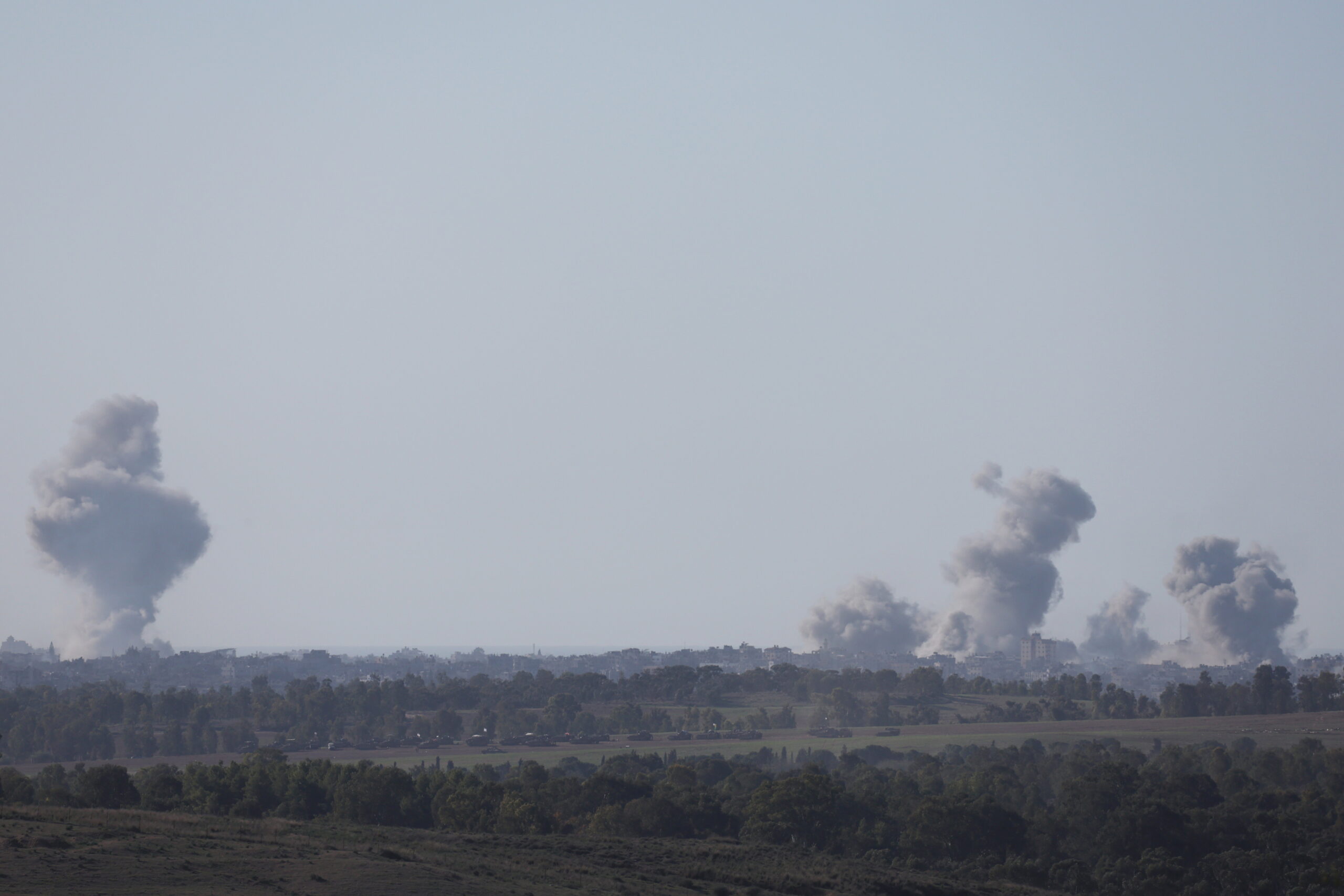 epa11044584 Smoke rises above Al-Bureij refugee camp in the central Gaza Strip following Israeli army shelling, as seen from an undisclosed location at the Gaza border, Israel, 26 December 2023. More than 20,000 Palestinians and at least 1,300 Israelis have been killed, according to the Palestinian Health Ministry and the Israel Defense Forces (IDF), since Hamas militants launched an attack against Israel from the Gaza Strip on 07 October, and the Israeli operations in Gaza and the West Bank which followed it.  EPA/ATEF SAFADI