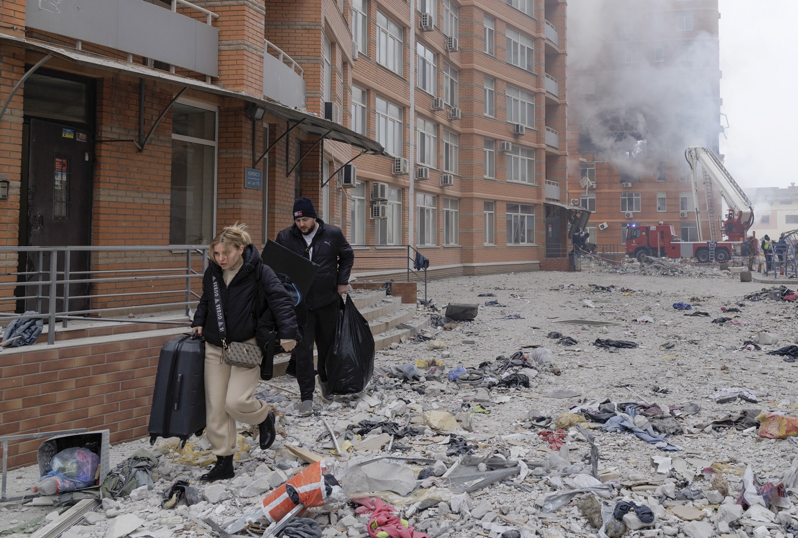 epa11048268 Locals carrying their belongings walk among debris after leaving their flat at the site of a damaged residential building after shelling in Odesa, southwestern Ukraine, 29 December 2023, amid the Russian invasion. At least 18 people have died and over 130 were injured after Russia launched a wave of airstrikes across Ukraine, Ukraine's Ministry of Internal Affairs said on 29 December. Strikes were reported in Kyiv, Lviv, Odesa, Dnipro, Kharkiv, Zaporizhzhia, and other Ukrainian cities. Russia launched 'more than 150 missiles and combat drones' at Ukrainian cities, Ukraine's Prosecutor General Andriy Kostin said in a statement, adding that extensive damage included residential buildings, educational institutions and hospitals. Russian troops entered Ukraine on 24 February 2022 starting a conflict that has provoked destruction and a humanitarian crisis.  EPA/IHOR HORA