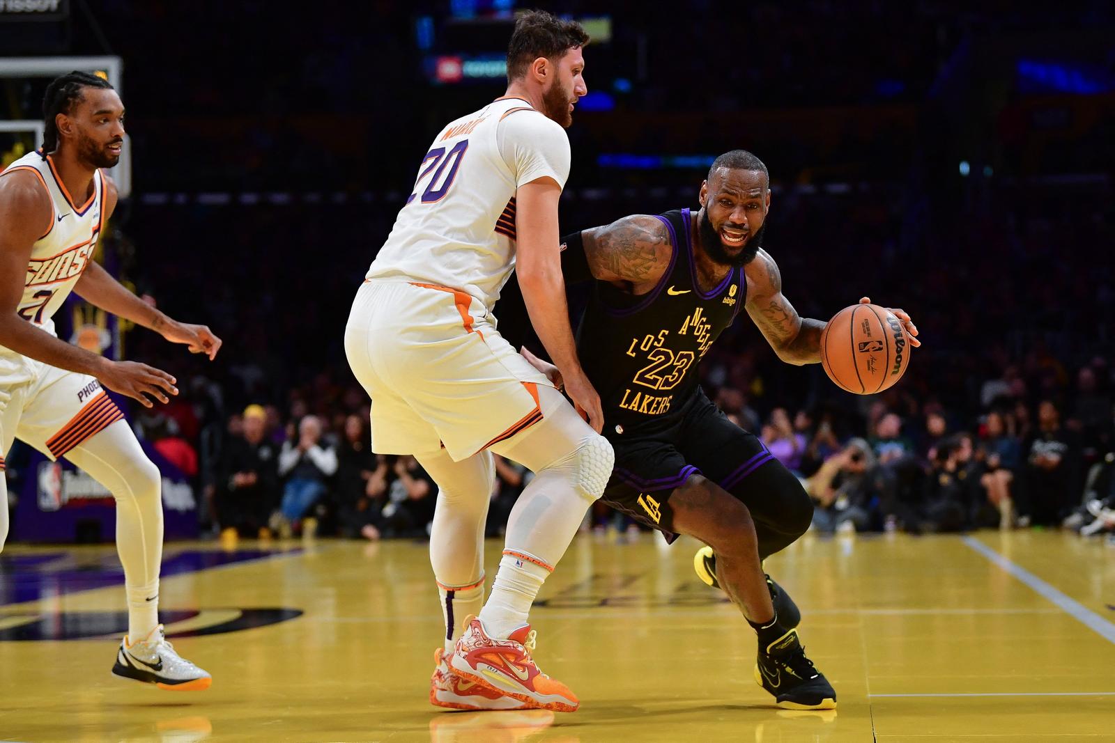 Dec 5, 2023; Los Angeles, California, USA; Los Angeles Lakers forward LeBron James (23) moves the ball against Phoenix Suns center Jusuf Nurkic (20) during the first half of the In Season Tournament quarterfinal at Crypto.com Arena. Mandatory Credit: Gary A. Vasquez-USA TODAY Sports Photo: Gary A. Vasquez/REUTERS